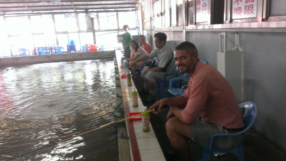 Fishing away. A good excuse to have a cold drink... green tea in this case (when in Taiwan)...